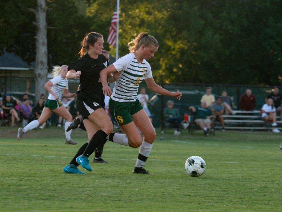 Ilse De Jong maneuvers the ball past a MACU defender during a matchup earlier this season. 