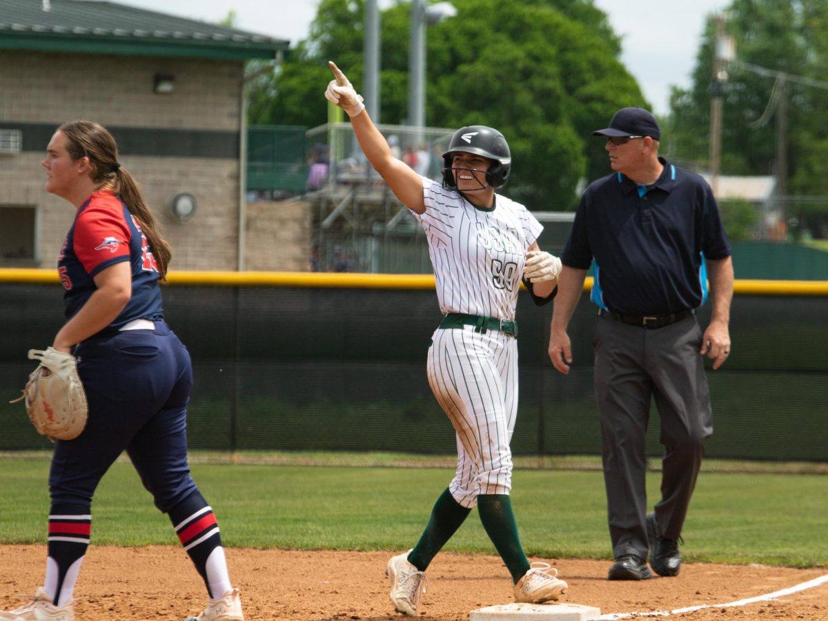 Junior first basemen Jadyn Goucher points to the air after a play against Oklahoma Panhandle State University in their matchup from the 2024 season.