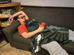 Gary Jackson passed out on a couch after partying. (Disclaimer: this photo was staged for the purpose of the article and does not condone drinking.) 