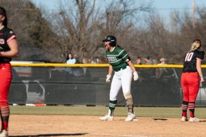 Senior Sierra Selfridge celebrates after getting on-base during game against Northwestern College on Feb. 24. 