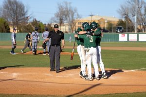 Boone Lasater celebrates at home plate with his teammates in Tuesday's 24-1 win over Randle University 