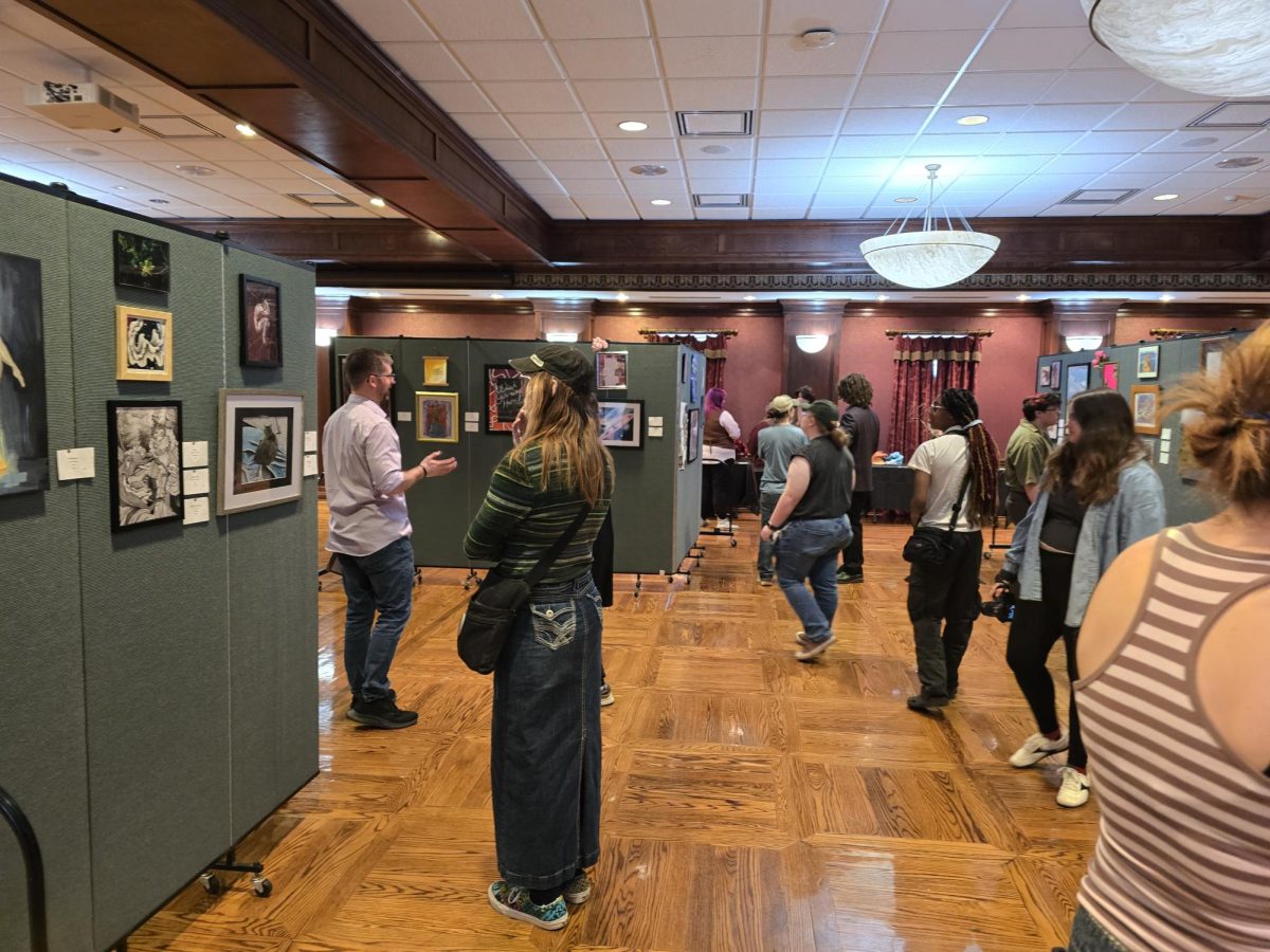 Visitors gather and view various artworks at the Multiplicity show