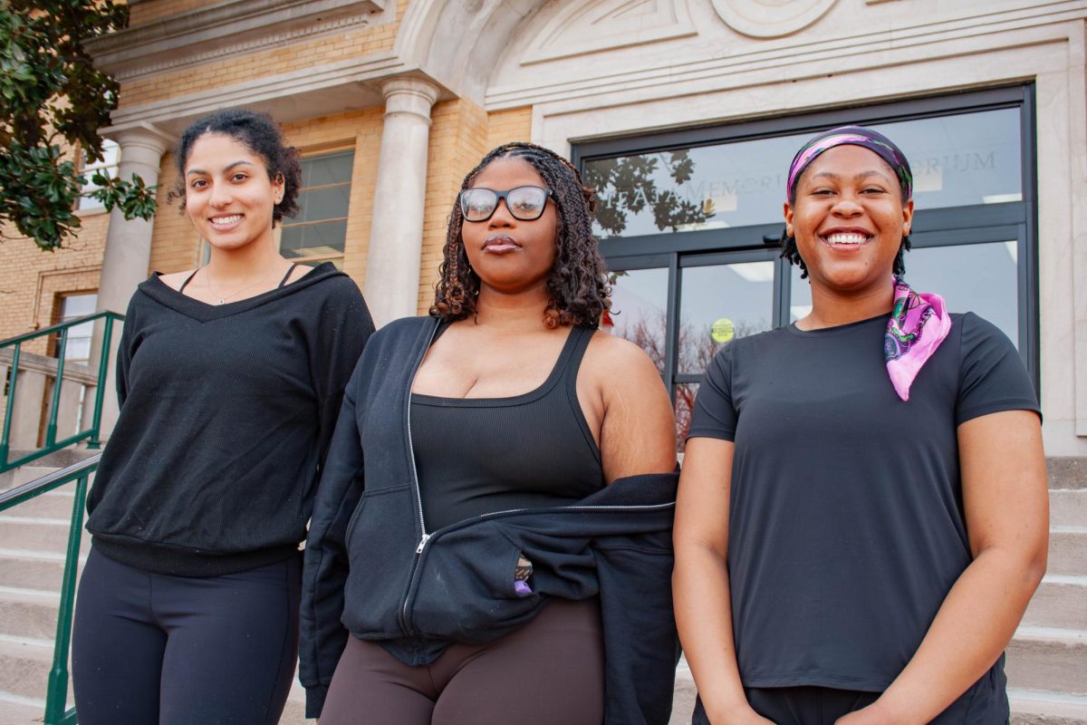 Chloe Conover (left), Samaya Green, and Trinity Chatman (right) smile on the steps of Troutt Hall.