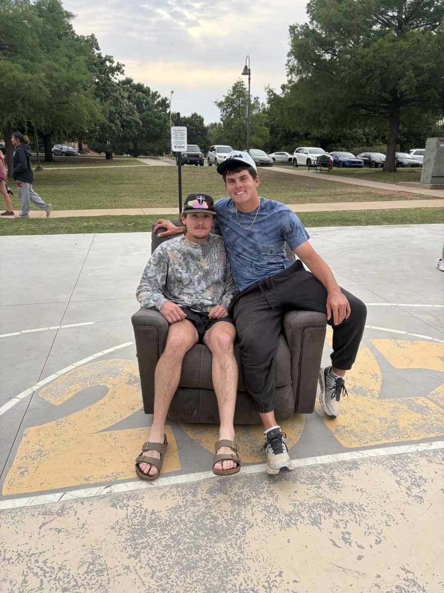 Cornhole tournament winners Cooper Hamilton (left) and Jace Brandenburg claim their prize recliner.